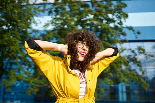 happy girl in a yellow raincoat Squeal for joy