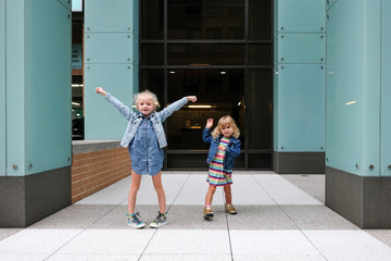 girls playing outside of apartment building