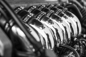 The detail of the V6 sport engine with shiny chrome exhaust tubes. 