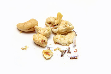 A picture of cashew nuts infested with caterpillars and butterflies of the meal moth. Isolated on a white background. 