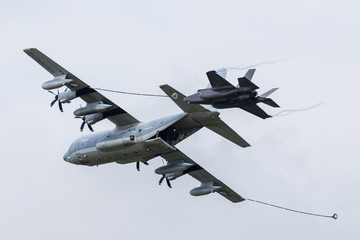 F-35B stealth fighter behind a C-130J