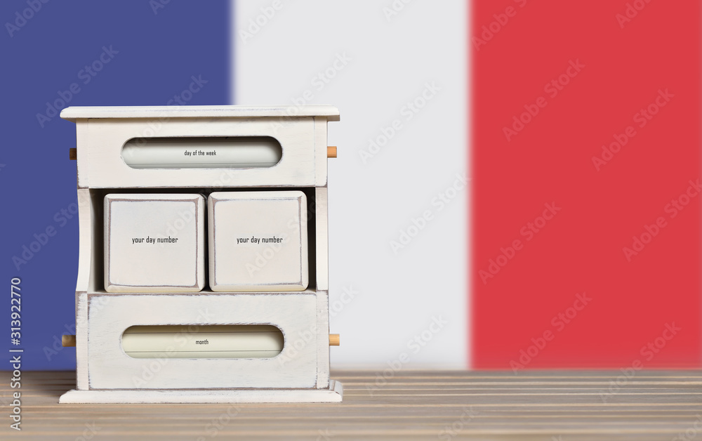 Fototapete wooden retro calendar with free space for a date on the background of the flag of france. template f