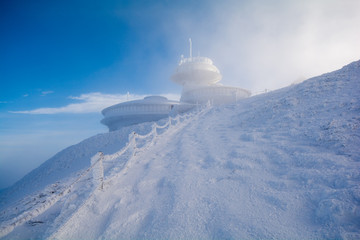 Fototapeta na wymiar peak of Sniezka mountain in Giant Mountains in Poland and Czech republic border during winter