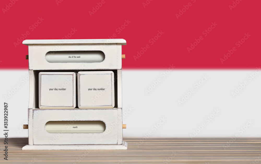 Fototapete wooden retro calendar with free space for a date on the background of the flag of indonesia. templat
