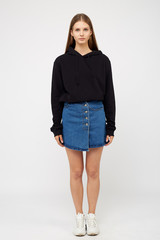 girl in a denim skirt and a black jacket