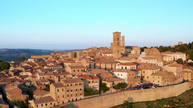 Aerial view of Volterra, Italy at sunset. Wide view of ancient architecture and city walls 