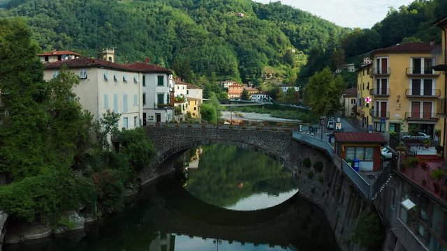 Bagni di Lucca (formerly Bagno a Corsena), Italy, Aerial push over old stone bridge 