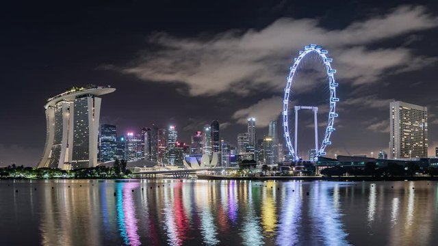 TL/ Asia, Singapore, night to day transition, time lapse of the financial district and Singapore skyline at dawn, showing Marina Bay Sands and Singapore flyer in foreground.