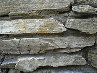 Wall made of flat gray rock stone