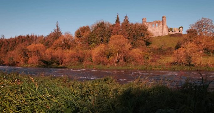 Colorful 4K video of Boyne valey, river and surroundings with Dunmoe castle on thee background, during sunny golden autumn evening, Co. Meath, Ireland