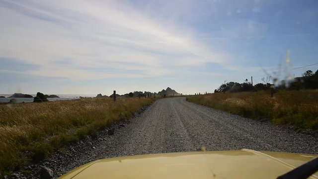 Driving a gravel road in mini car in Cape Palliser