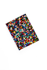 Fototapeta na wymiar Ironing beads in a box on white background