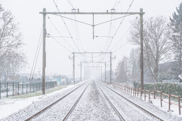 Railway covered in snow in Holland on a cloudy winter's day