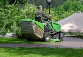 Fototapeta premium Professional lawn mower cuts the grass