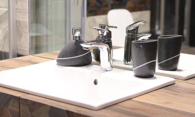 Sink with crane and bathroom mirror, soap containers