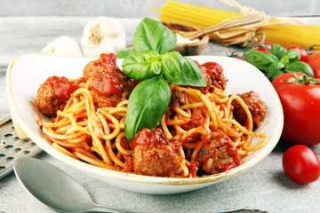 Spaghetti pasta with meatballs and tomato sauce with basil and parmesan