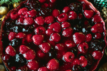  New year's still life. Cake from the berries. Delicious dessert. Christmas toys, garlands, cones.