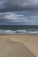 Clouds and soft colours in beach view with sandy ridge