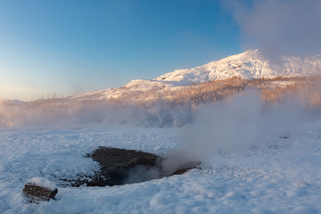 Geysir geothermal area on the golden circle in Iceland during the winter on a clear day
