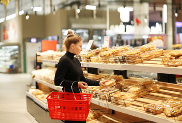 Woman choosing bread from a supermarket