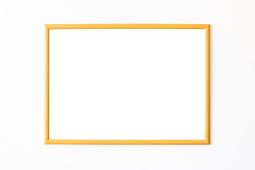 Empty wooden square frame in front of white wall
