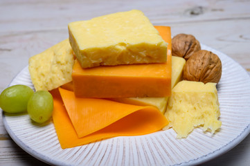 Cheese collection, blocks and slices of yellow and matured english cheddar cheese