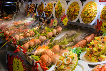 Chinese street food. Street trading. Chinese kinds of fresh seafood at an asian seafood market in Sanya, Hainan province, China. Inscription: name food.
