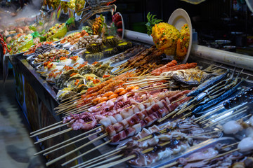 Chinese street food. Street trading. Chinese kinds of fresh seafood at an asian seafood market in Sanya, Hainan province, China. Inscription: name food.