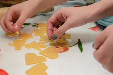 DIY homemade cookies, women's and children's hands make cookies from dough