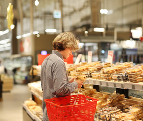 Teenager choosing bread  from a supermarket