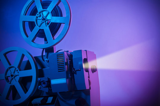 Vintage old fashioned projector in a dark room projecting a film