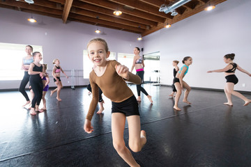 Group of kids jumping and playing in dance class