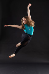 Portrait of young ballet dancer jumping in the air