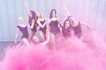 Group of dancers in colorful smoke bomb