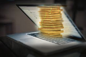 gold coins and laptop. Close-up. Business concept.