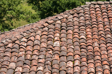 Old vintage red ceramic roof tiles closeup as background