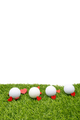 Golf ball and red heart for valentine with love are on green grass