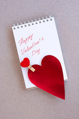 Valentines day red hearts greeting card over paper background..