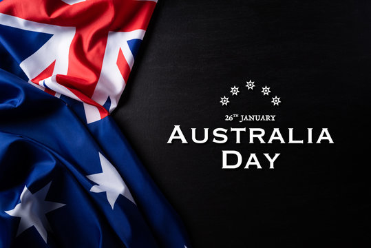 Australia day concept. Australian flag with the text Happy Australia day against a blackboard background. 26 January.