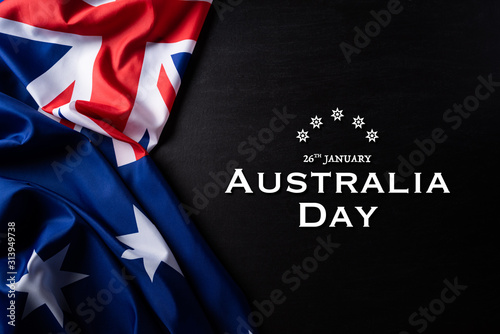Australia day concept. Australian flag with the text Happy Australia day against a blackboard background. 26 January.