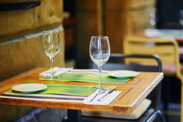Empty wine glasses on street bar table in San Sebastian, Spain