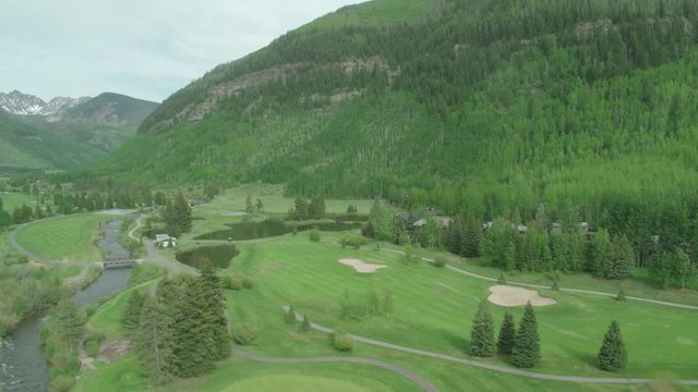 Vail Valley Summer Golf Course Aerial With River And Mountains Inspire 2 ProRes 422 HQ. Panning Right Along River. Medium Angle.