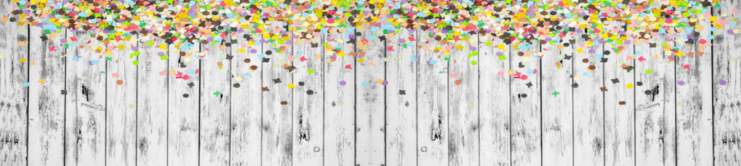 Happy Carnival background panorama banner long - Frame made of colorful confetti isolated on white rustic shabby wooden texture, with space for text