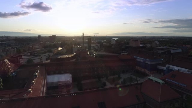 KTH Royal Institute of Technology university buildings in Stockholm, Sweden. Aerial drone shot flying over campus buildings at sunset