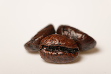 Three coffee beans on the white table