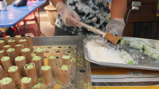 Man Cooking Putu Bamboo Dessert. Rice Flour And Grated Coconut. Traditional Malaysian Food. 4K Footage.