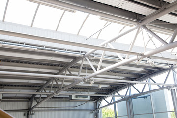 Fragment of roof construction in warehouse. Climate heat panels and lightning