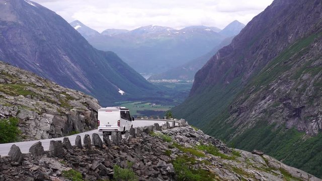 RV camper van drive on curvy canyon Trollstigen road. Famous scenic drive, Norwegian landmark & popular tourism destination. Norway in summer, 4k. 