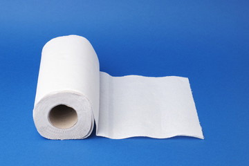 twisted roll of white paper towel on a blue background