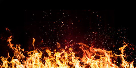 flames of fire on a black background - obrazy, fototapety, plakaty